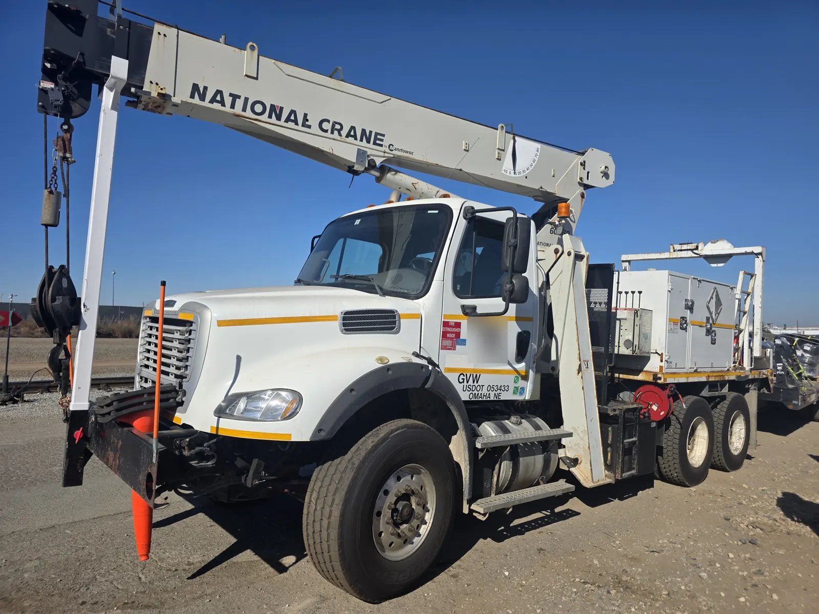 White Freightliner M2 crane truck with a National Crane boom at a Bay Area rail yard during a mobile fleet VIN verification.