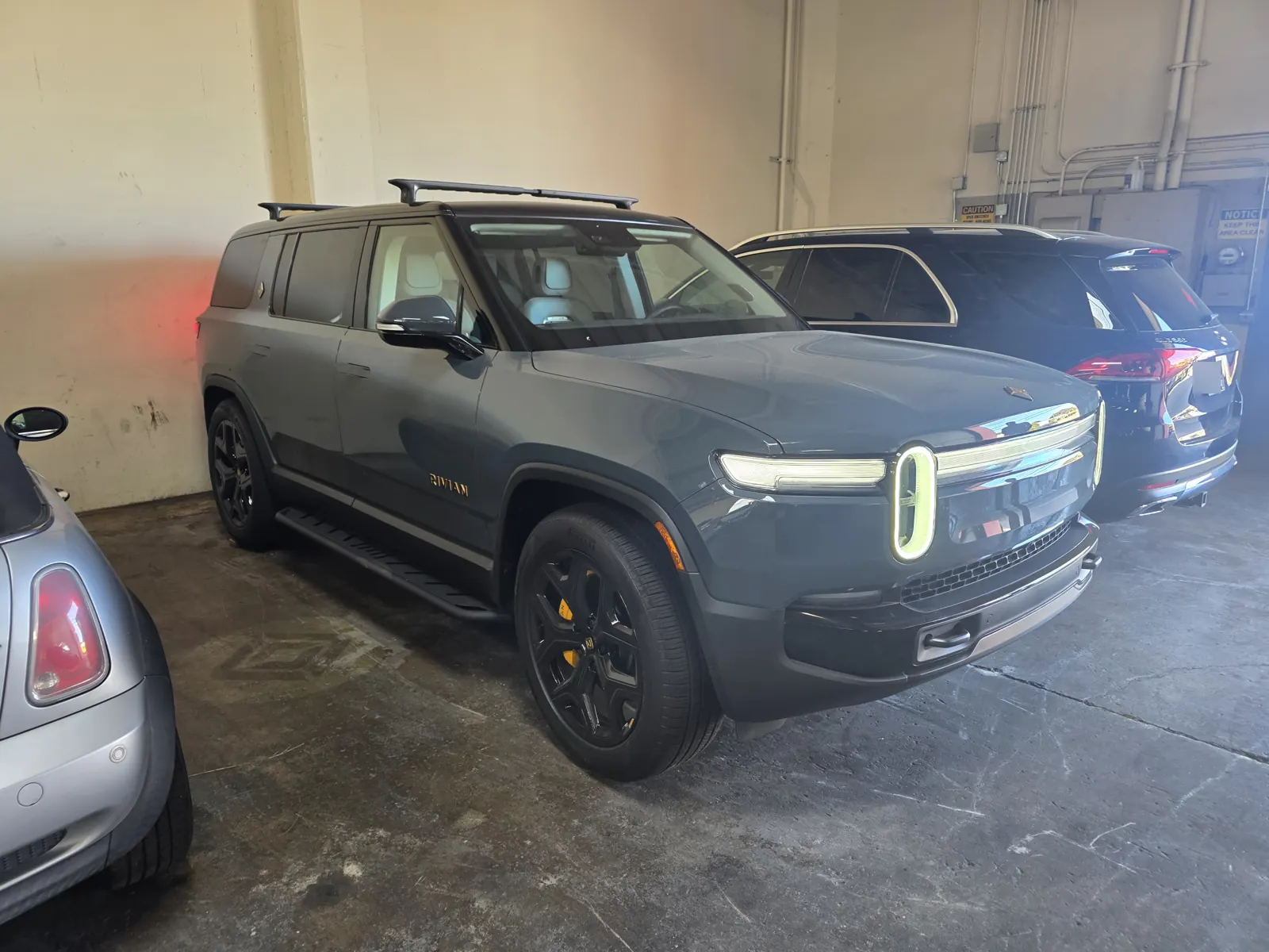 Grey Rivian R1S SUV parked indoors for a VIN verification.